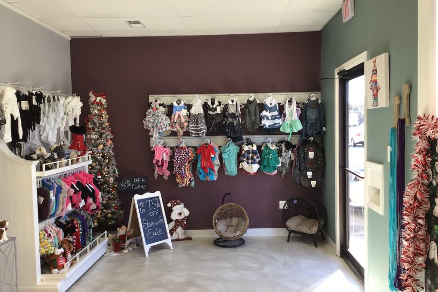 Shop interior, apparel wall display, entry door, storefront view