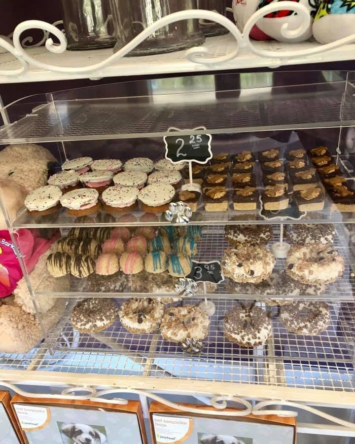 The treat case, iced cookies and pupcakes on tiered trays